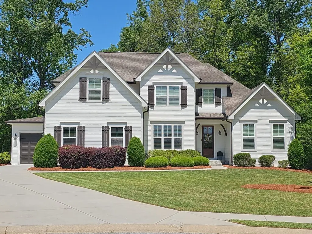 Home exterior with light siding and contrasting shutters